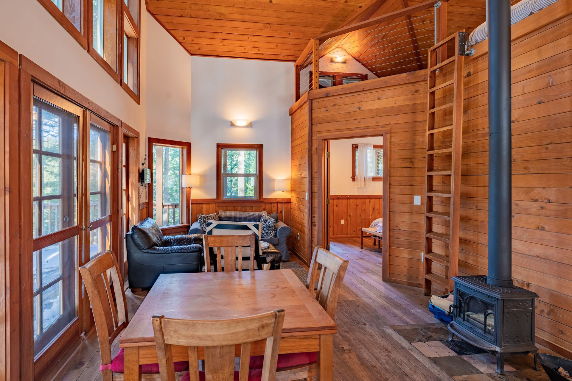 A wooden cabin with a dining table and chairs