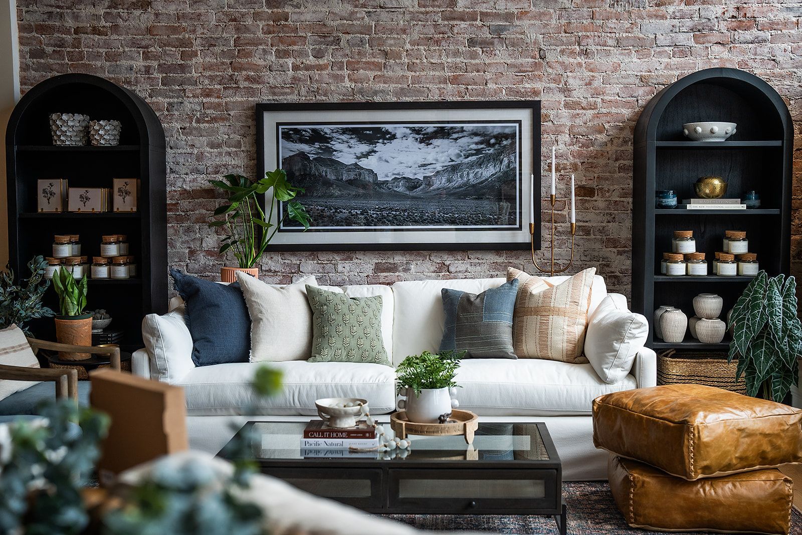 A living room filled with furniture and a brick wall.