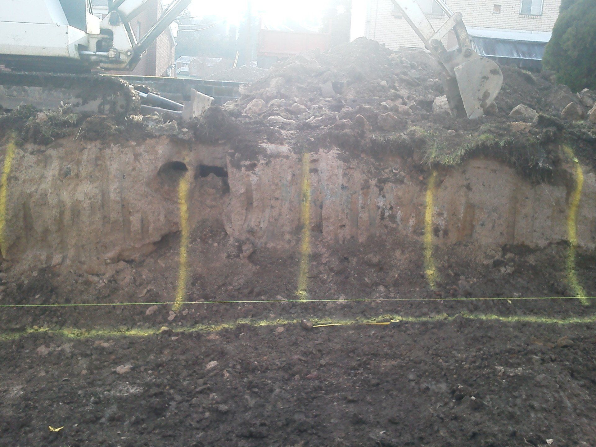 A large pile of dirt with yellow lines on it