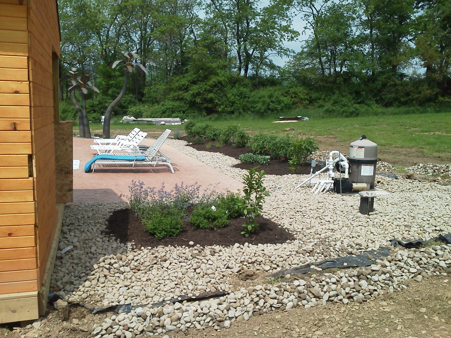 A wooden shed with a patio in the background