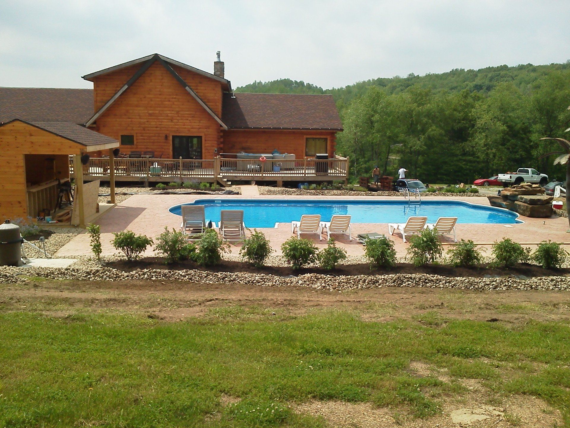 A large house with a large swimming pool in front of it