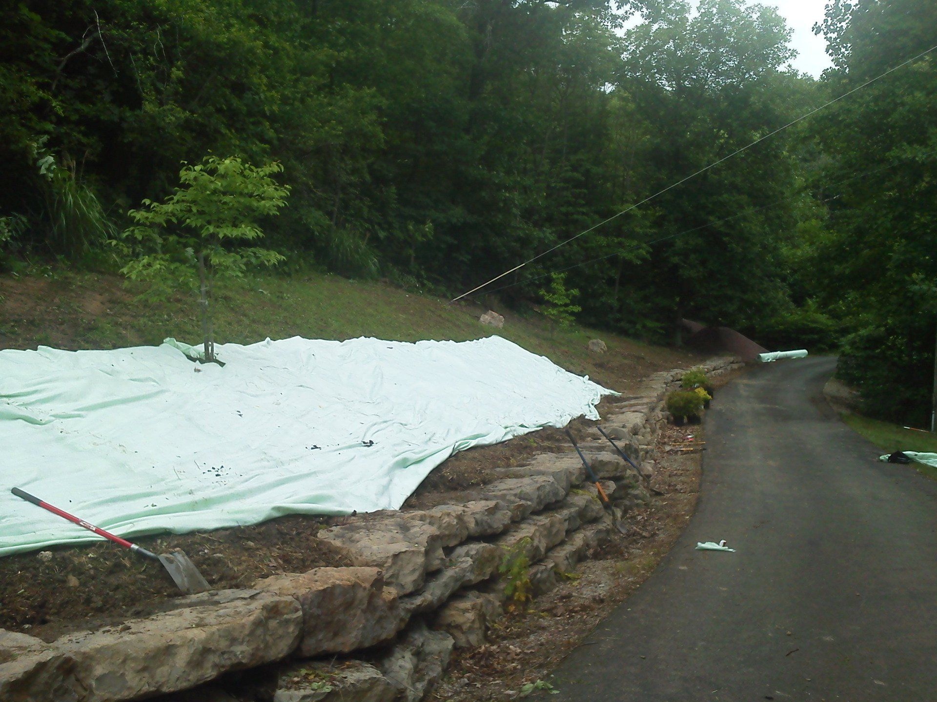 A road with a white tarp on the side of it