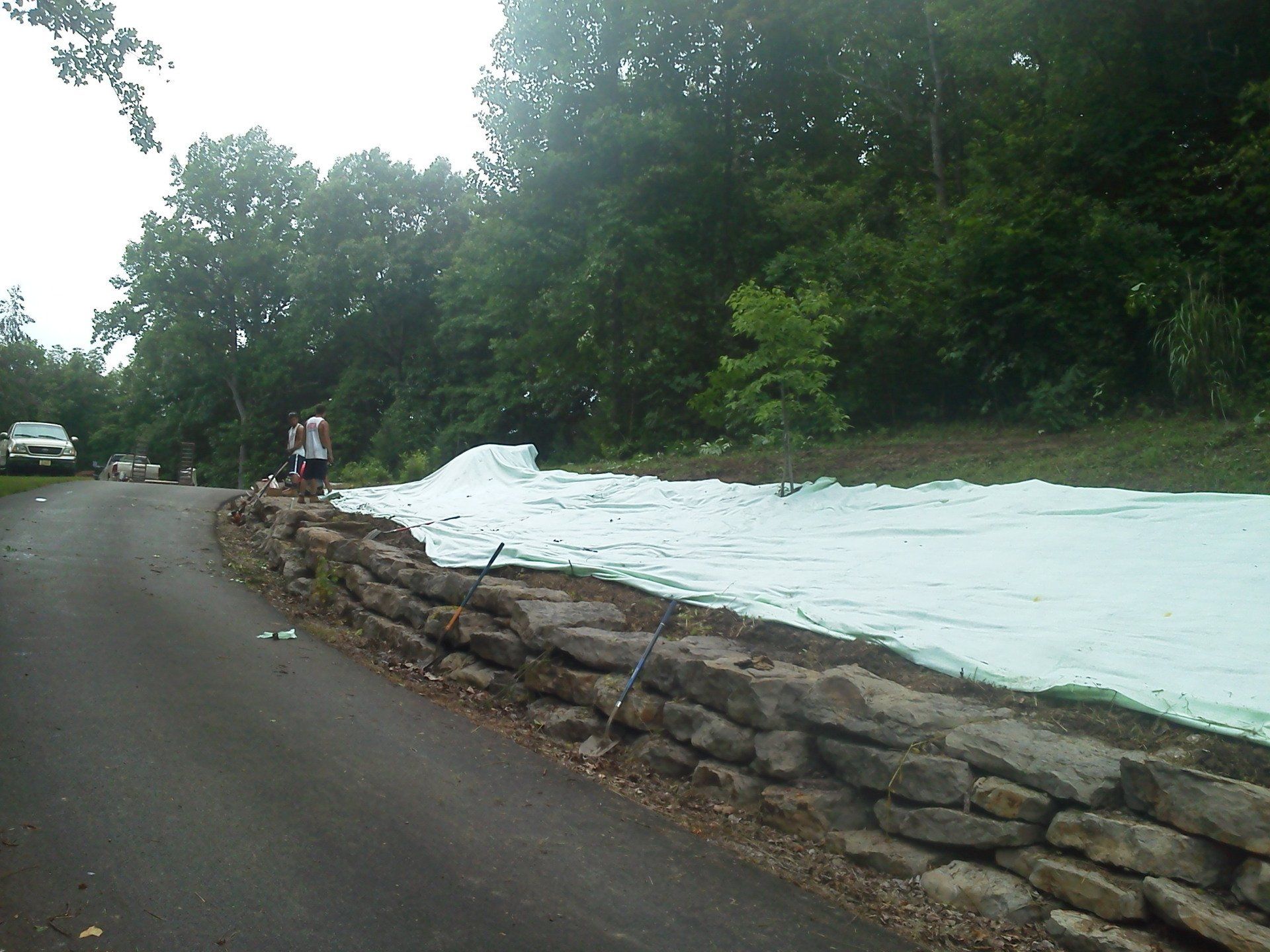 A road with a stone wall on the side of it