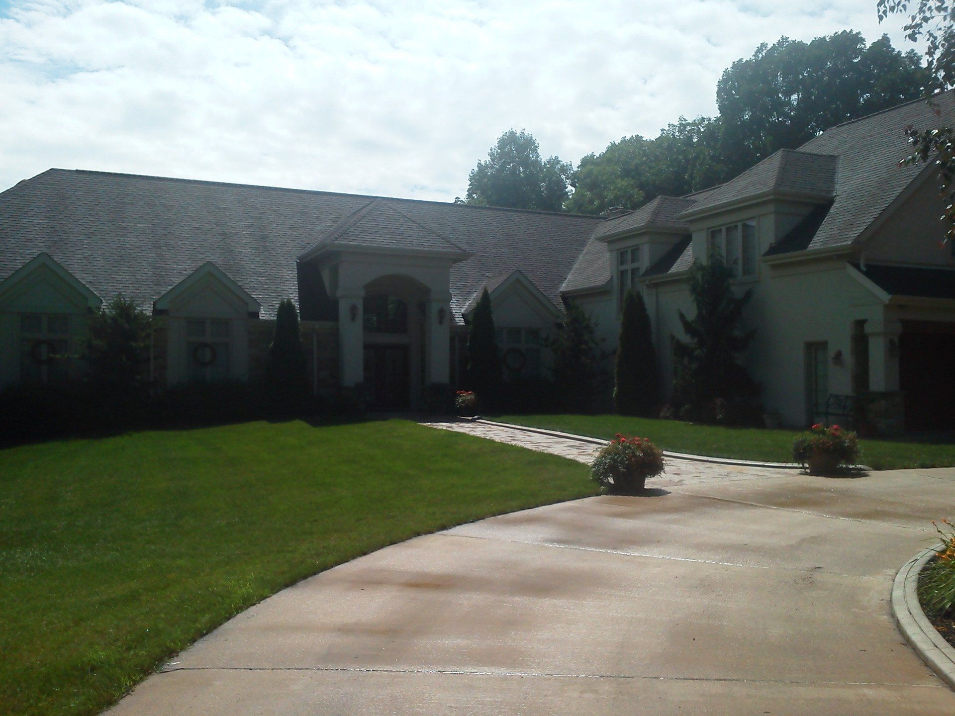 A large white house with a driveway leading to it