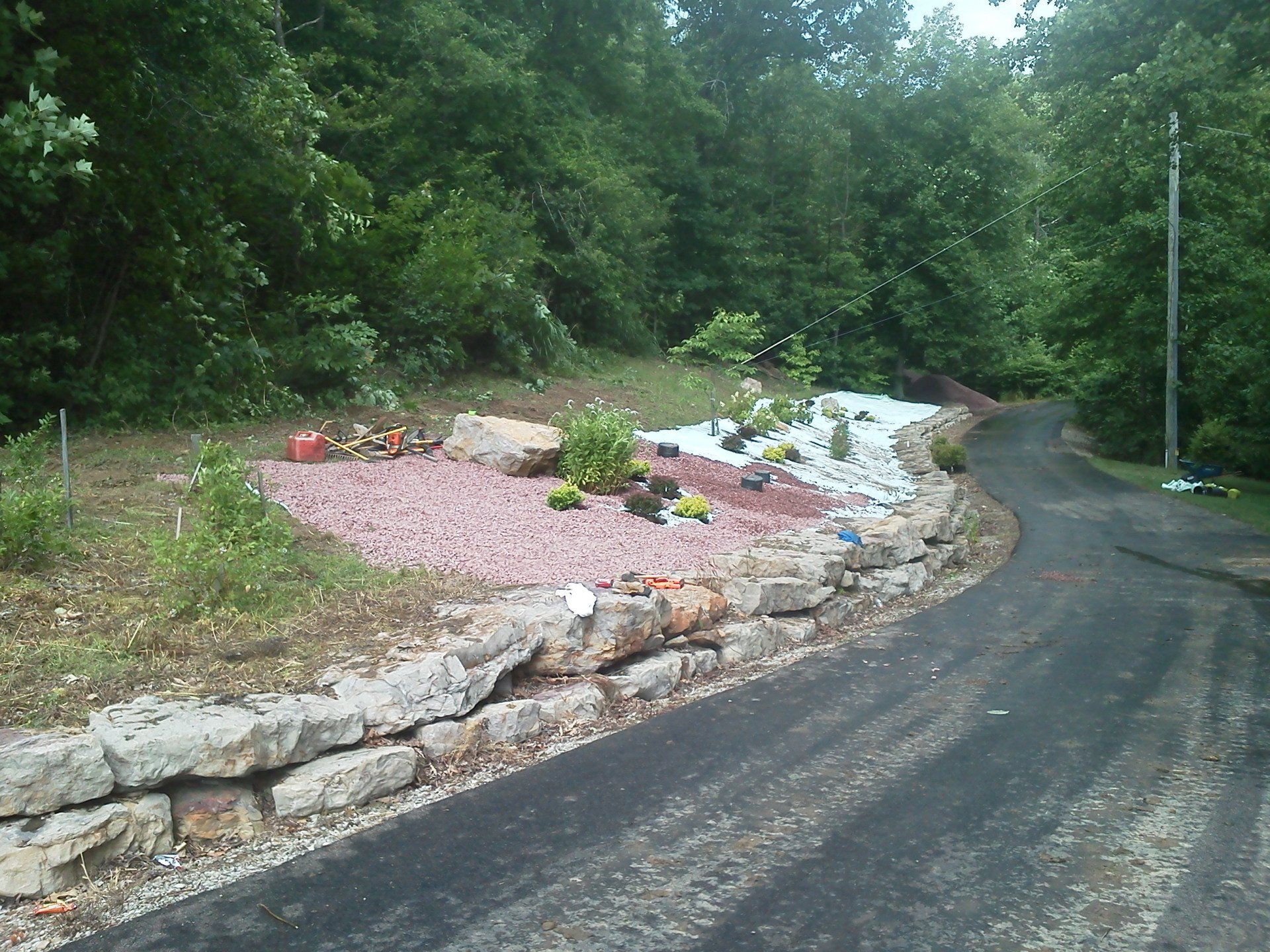 A road with a rock wall on the side of it