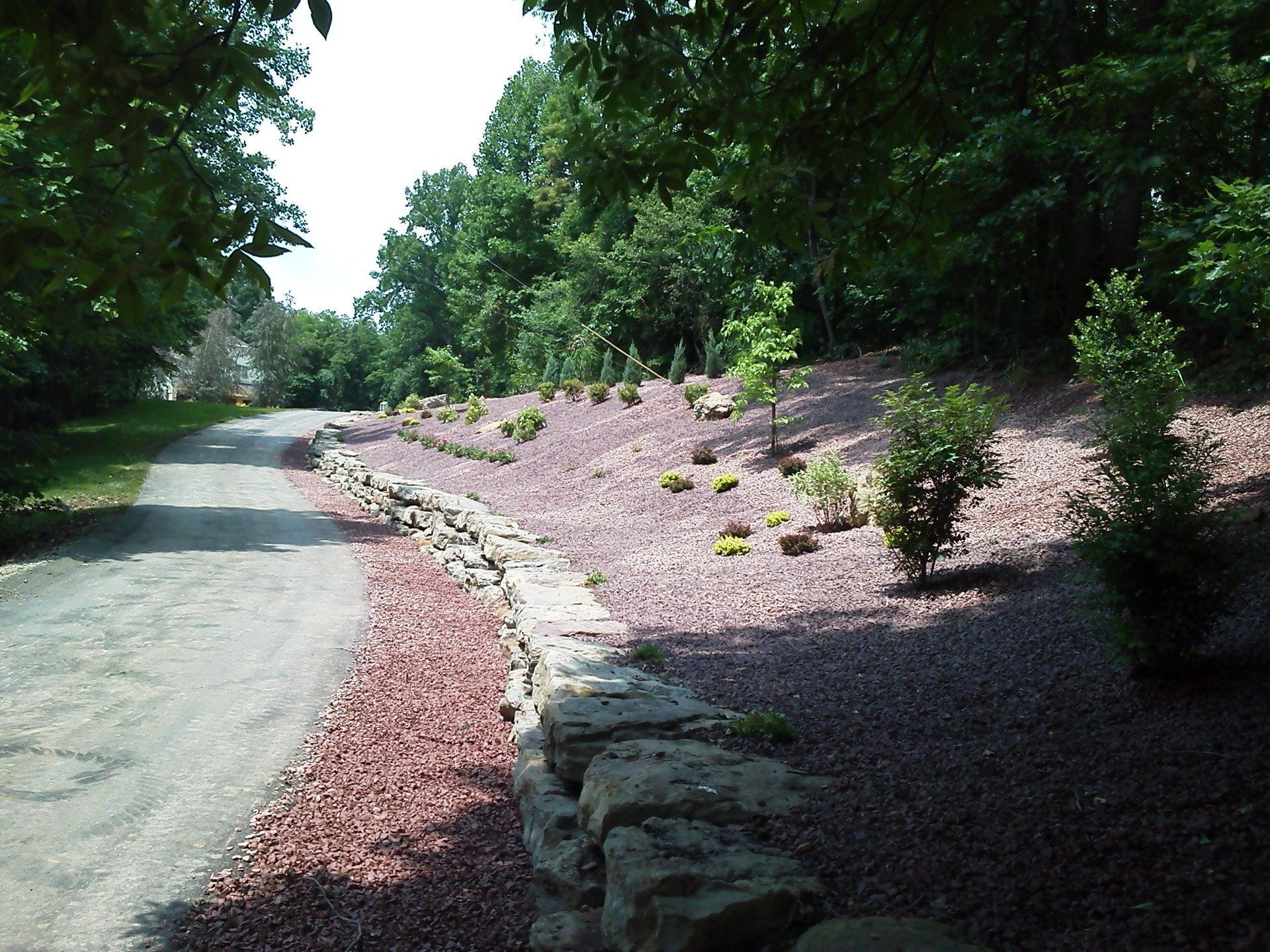 A stone wall along the side of a road