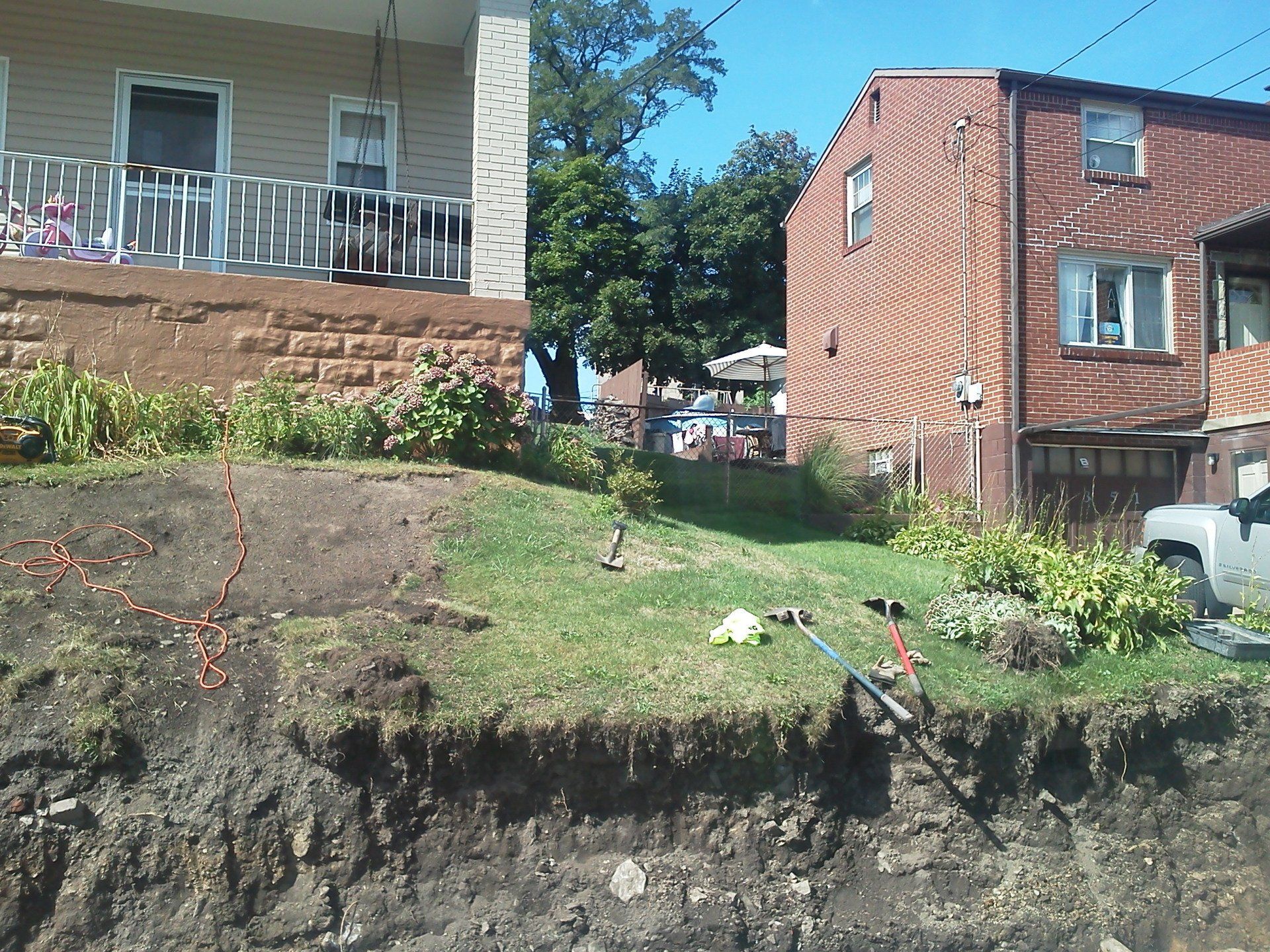 A truck is parked in front of a brick house