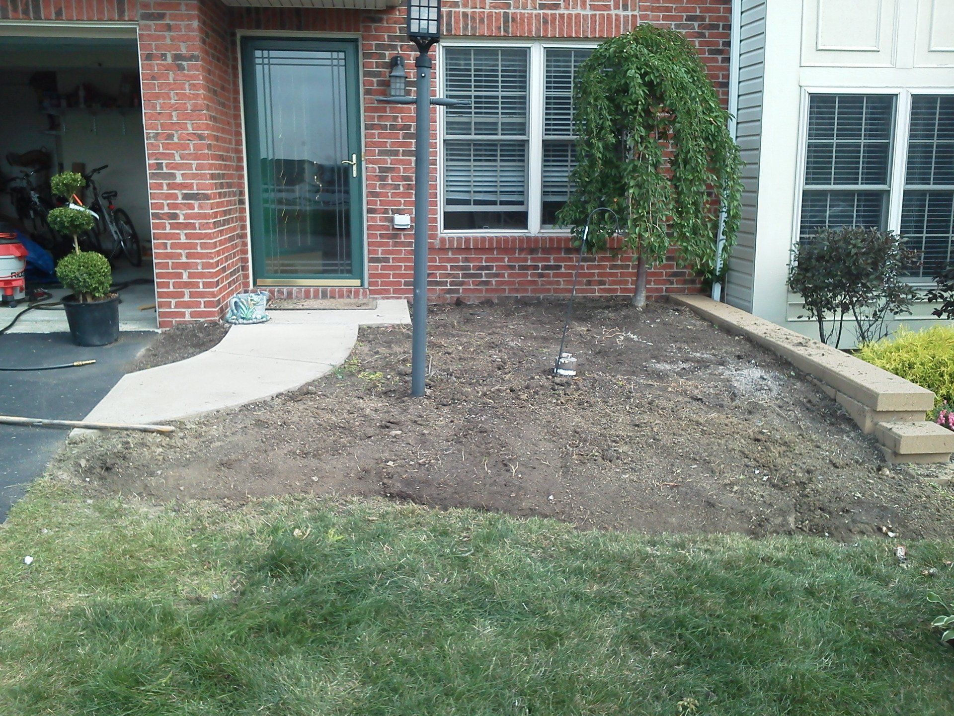 A brick house with a lawn in front of it