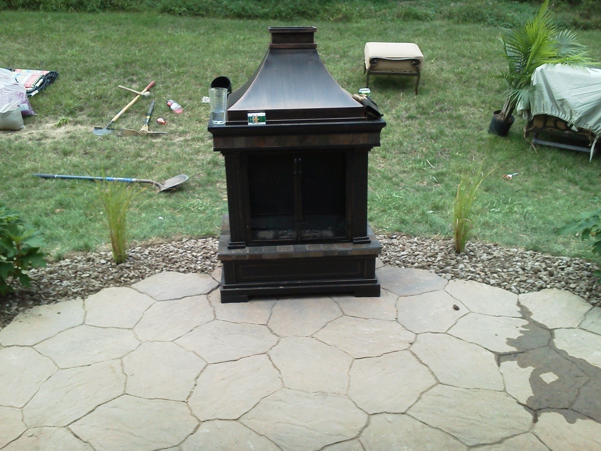 A patio with a fireplace in the middle of it