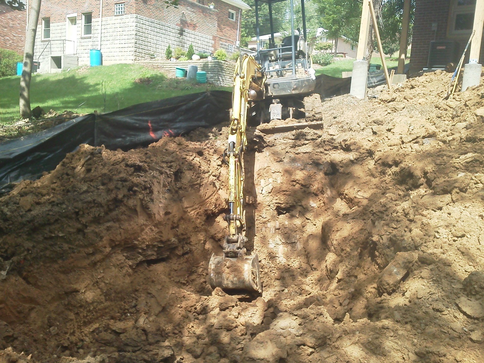 An excavator is digging a hole in the dirt