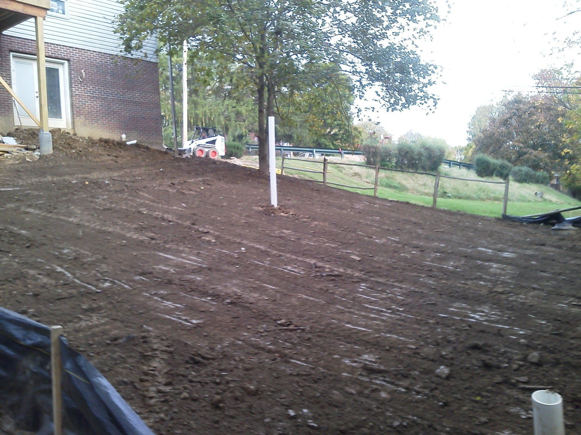 A large pile of dirt in front of a house