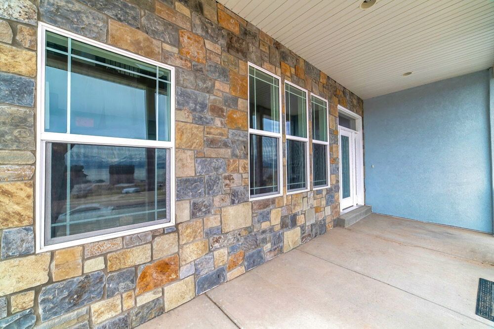 Stone Wall with Multiple Windows And Open Space in Front — G & A Glass & Aluminium in Cluden, QLD