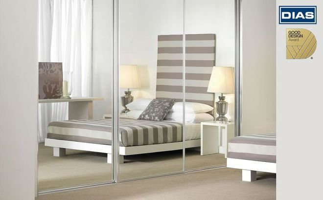 A Walk In Closet With Sliding Glass Doors and Cloths Hanging — G & A Glass & Aluminium in Cluden, QLD