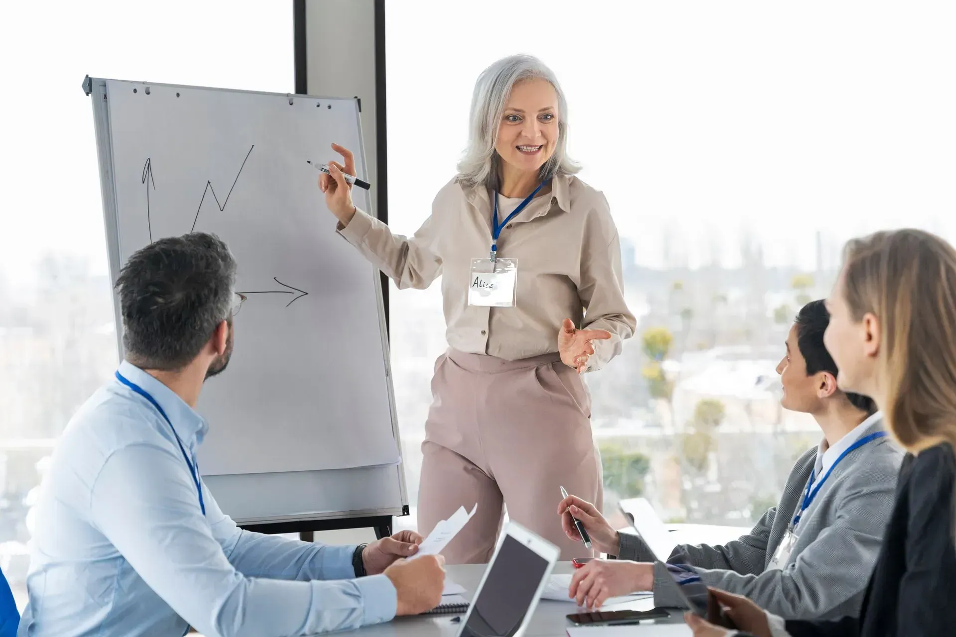 A woman is giving a presentation to a group of people.