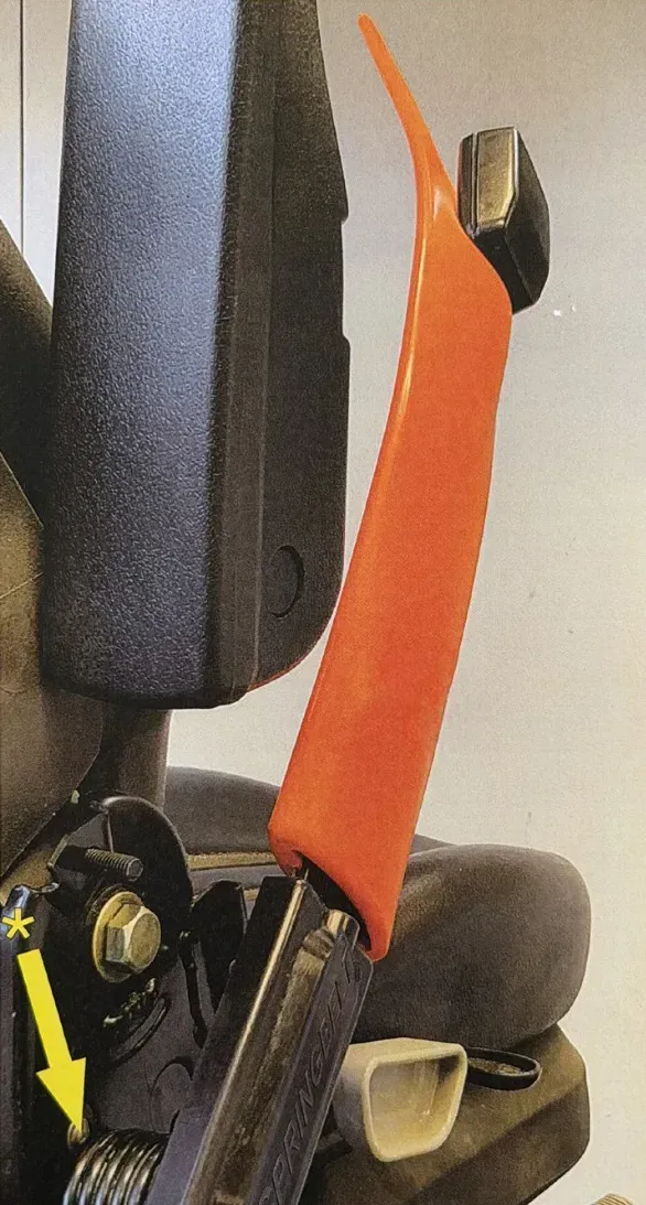 Close-up of an orange lever beside a black office chair armrest and seat cushion. Close-up of an orange lever beside a black office chair armrest and seat cushion.