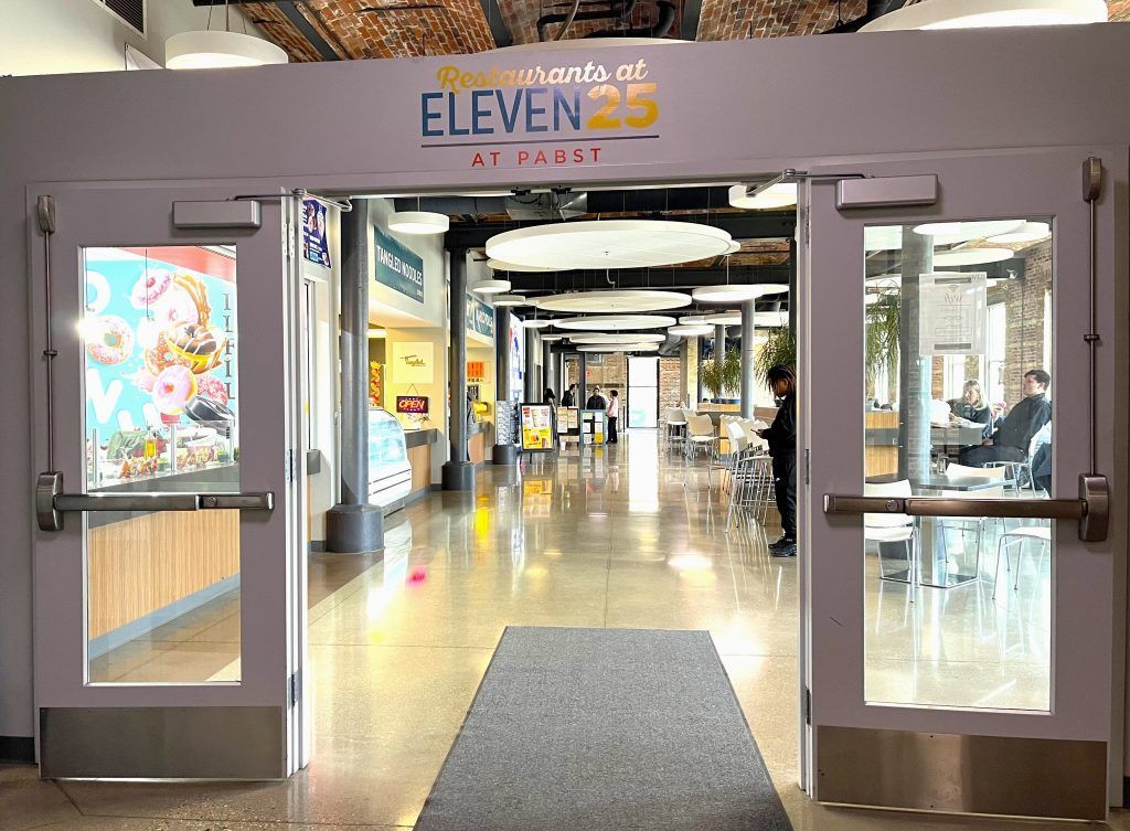 A large hallway with a sign that says eleven 25 on it.