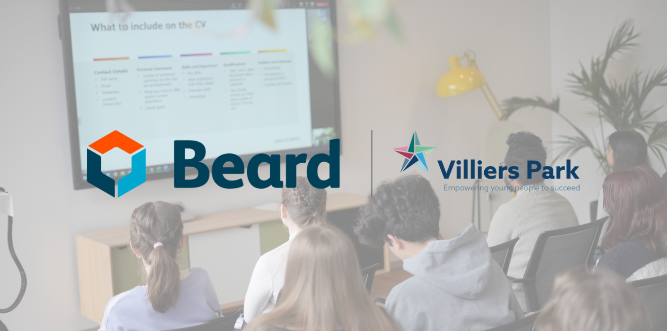 People seated in a classroom watching a presentation with Beard and Villiers Park logos on screen