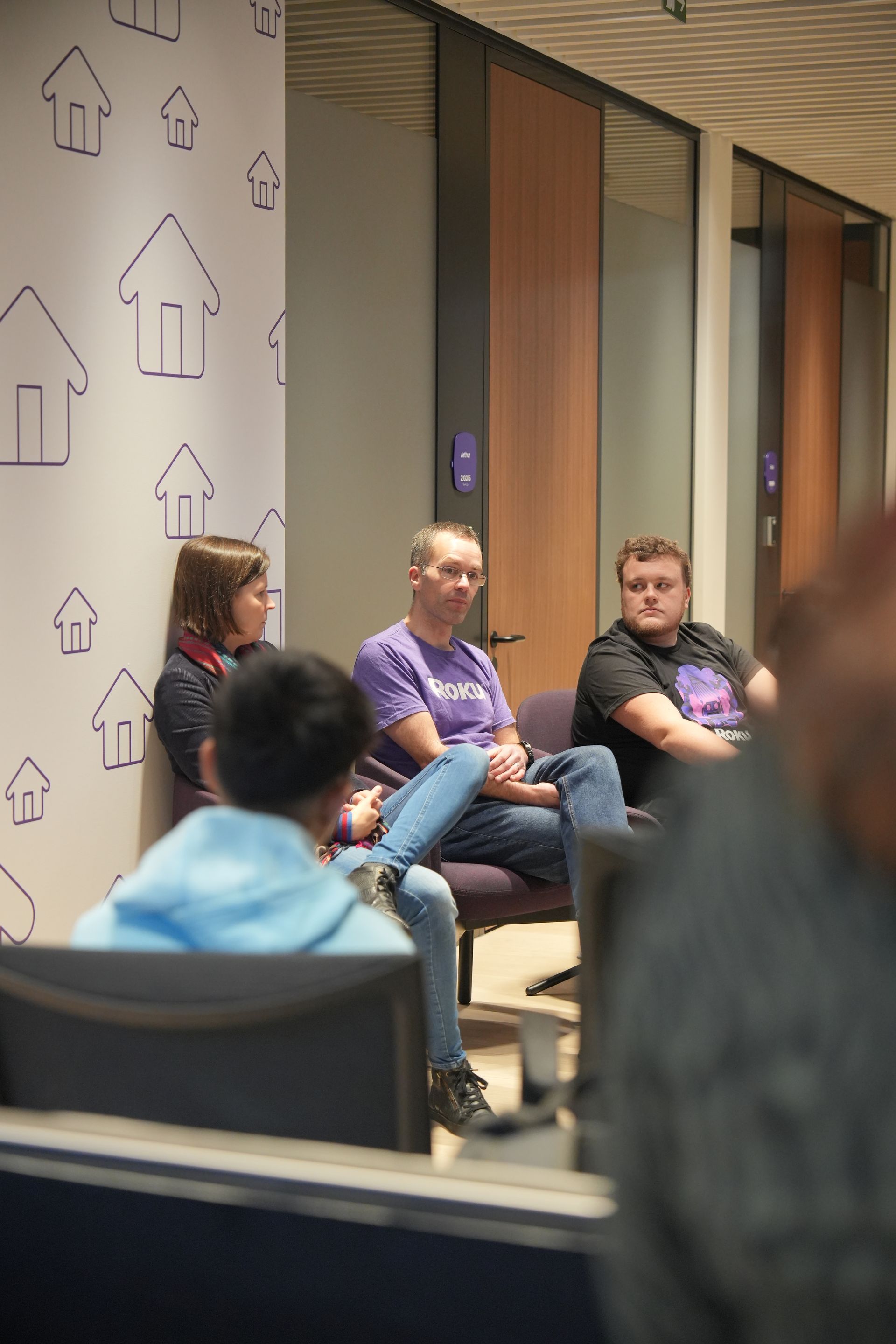 A group of people are sitting in chairs in a room.
