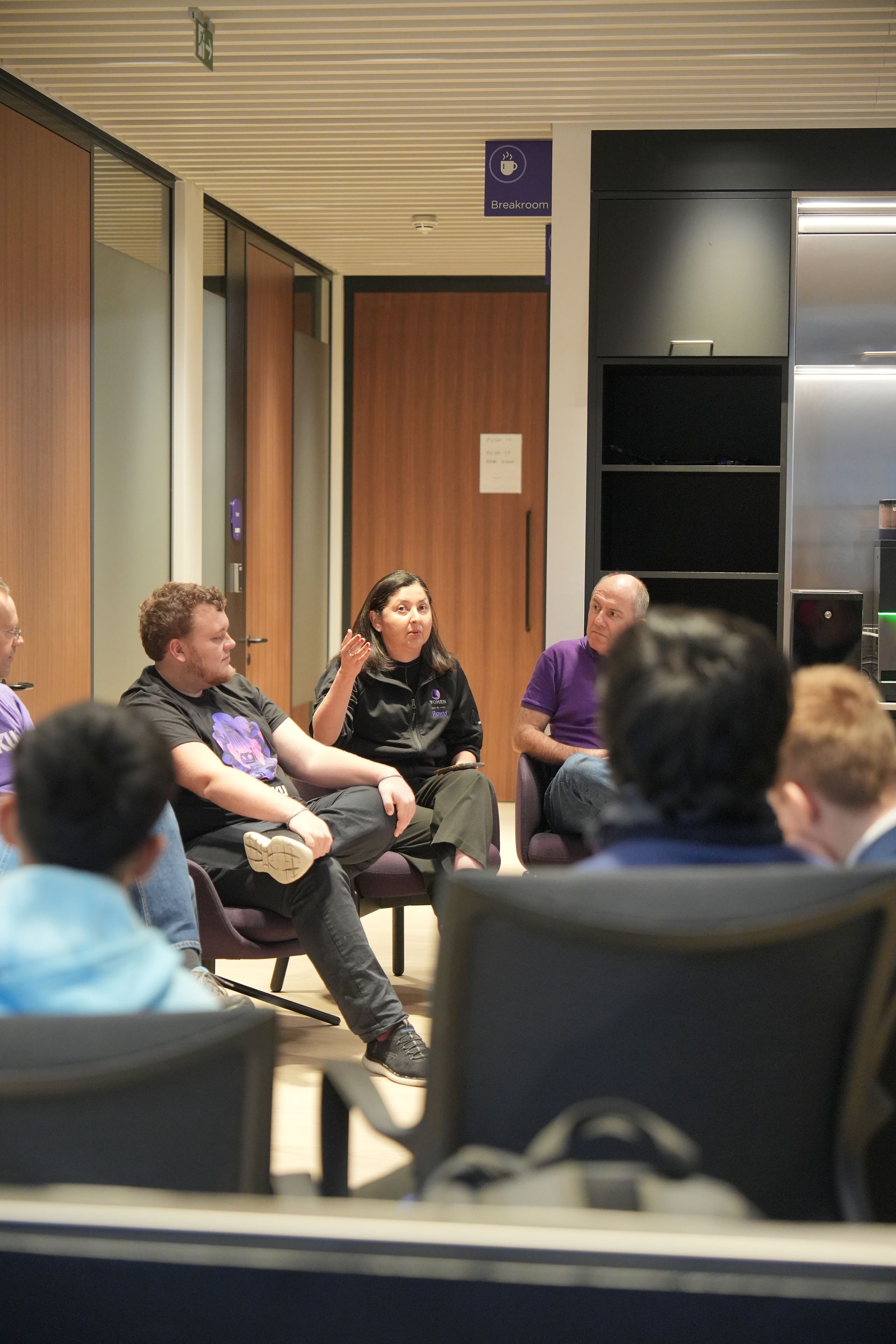 A group of people are sitting in a circle in a room.