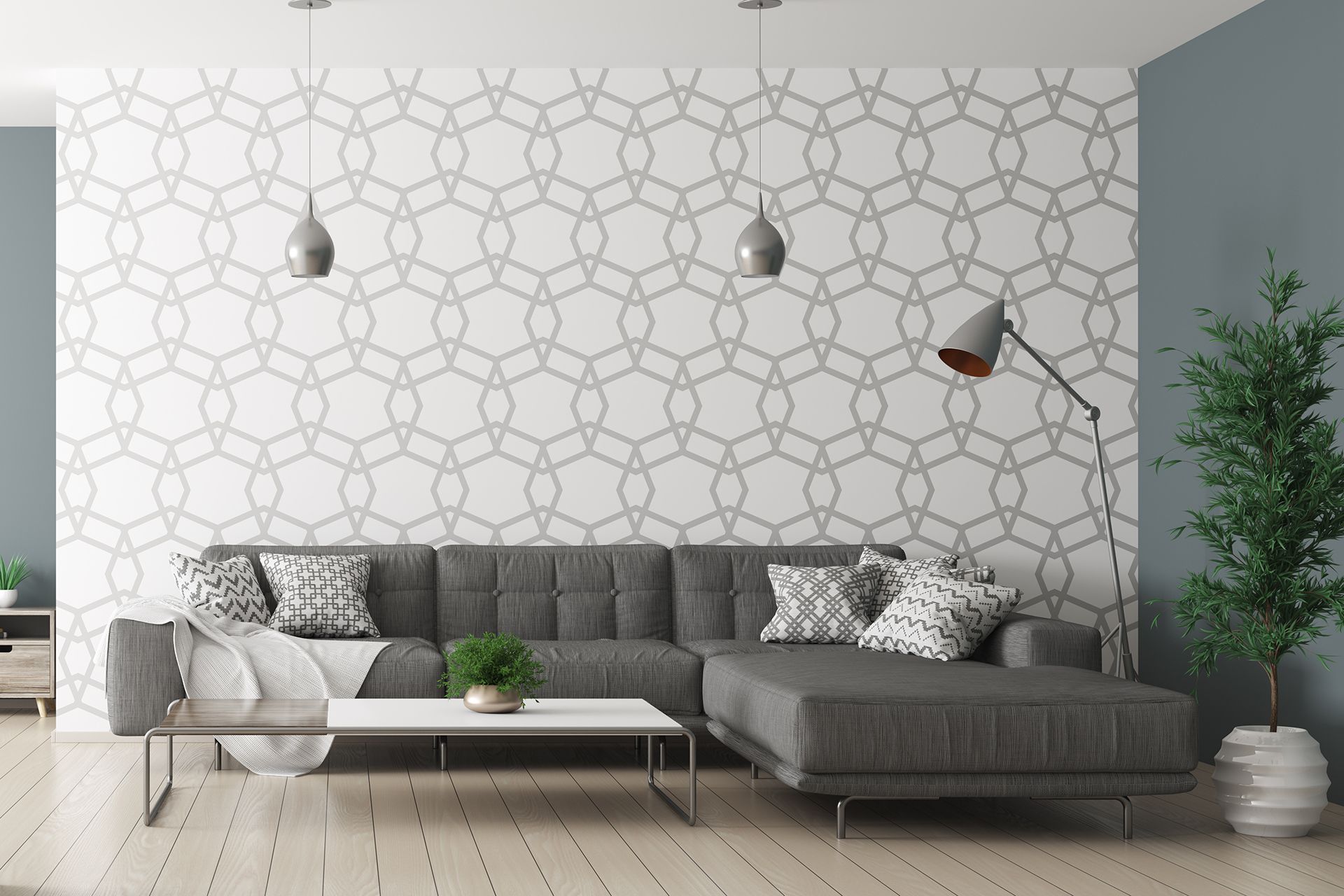 A living room with a gray sectional couch and a white coffee table.