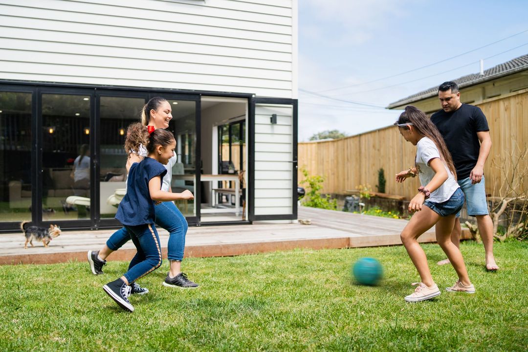 Family Playing On Their Backyard — Christchurch, NZ — Money For You Mortgages Family Playing On Their Backyard — Christchurch, NZ — Money For You Mortgages