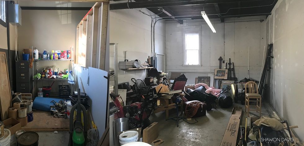 Cluttered workshop with tools, shelves, bikes, and equipment under bright overhead lights