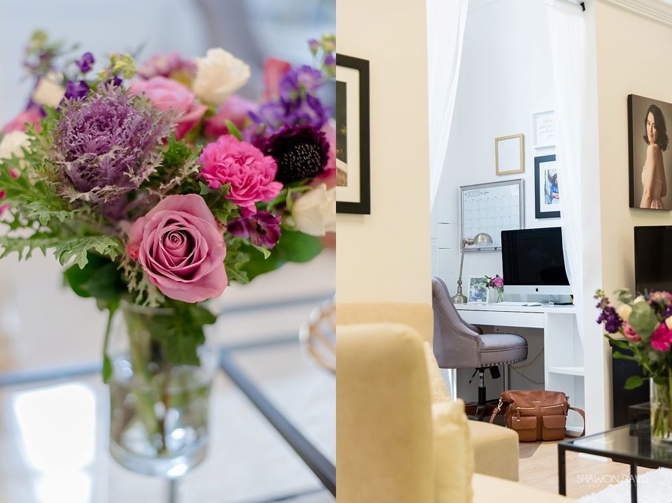 Bouquet of pink and purple flowers in a glass vase beside a bright home office