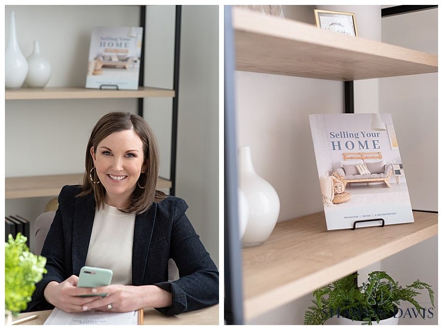Woman smiling at a desk beside a shelf with home decor and a book display