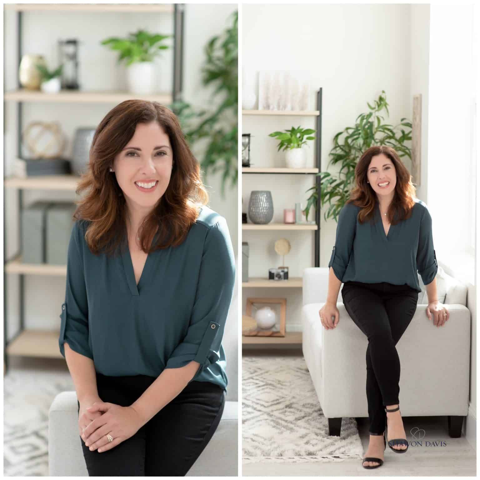 Woman seated in a bright living room, smiling beside a white chair and shelving with plants.