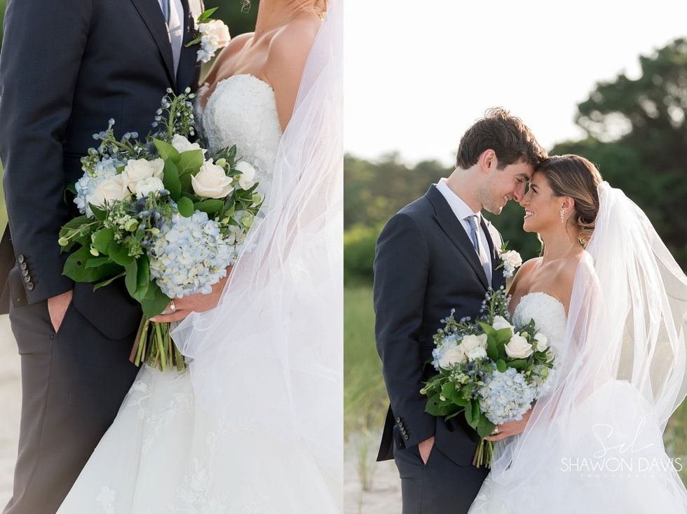 Wedding couple holding bouquets and kissing outdoors, with a bride in a white veil and groom in a dark suit