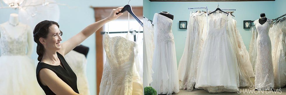 Woman holding up a white wedding dress in a bridal shop