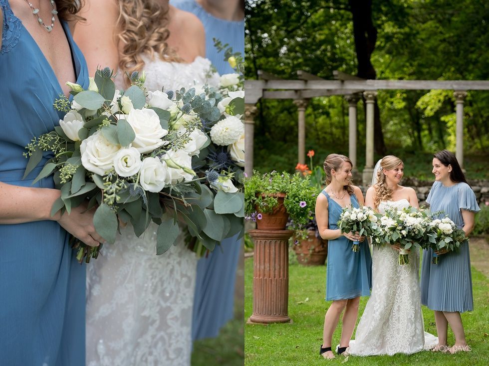 Bride holding white bouquet with bridesmaids in blue dresses at an outdoor wedding ceremony