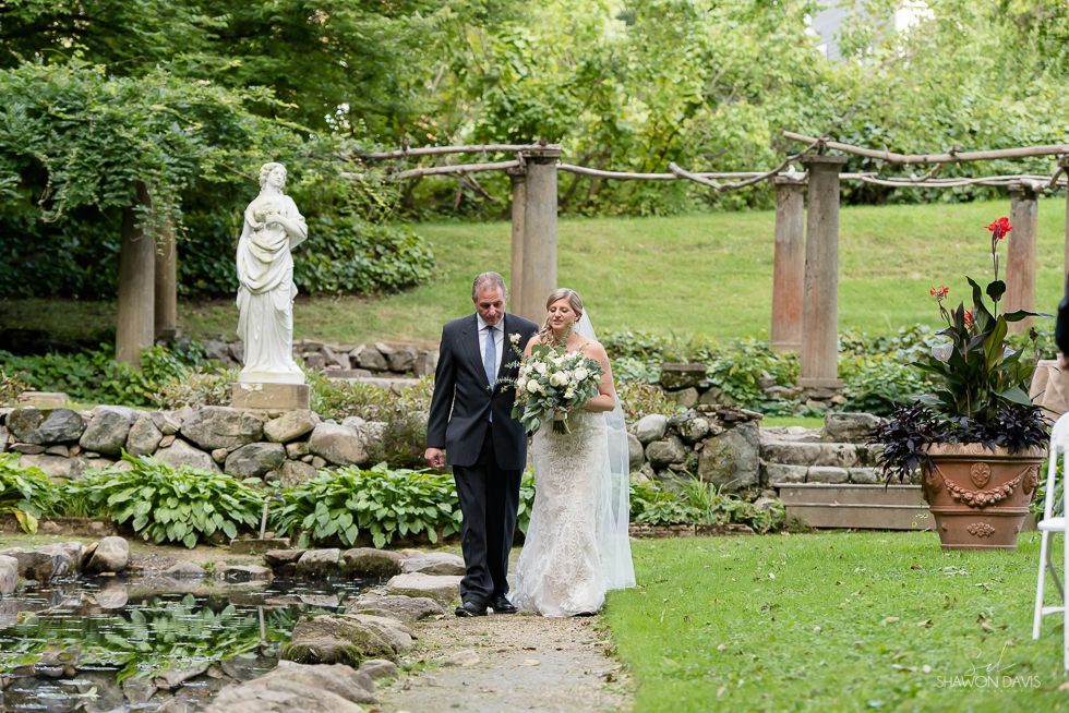 Bride and groom walking together in a garden wedding ceremony