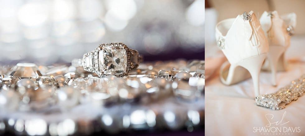 Close-up of sparkling wedding rings and bridal heels on a soft, glittery surface