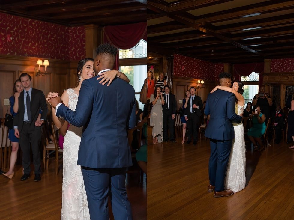 Couples slow-dancing at a formal reception in a wood-paneled ballroom