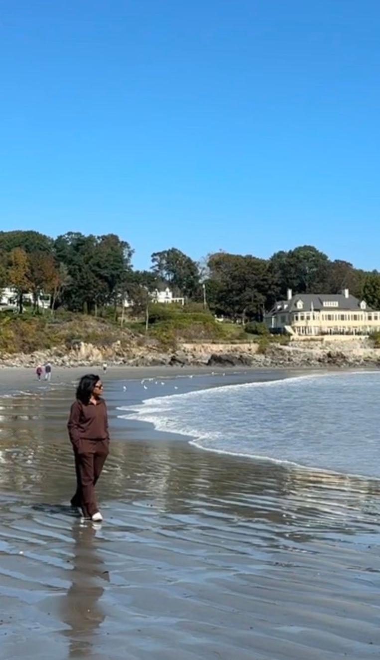 Woman walking along York, Maine beach near Stage Neck Inn