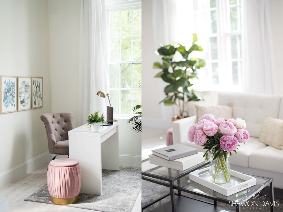 Bright modern living room with white sofa, pink flowers, glass coffee table, and large window light