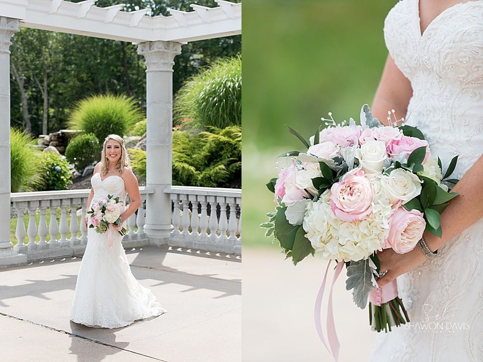 Bride in a white gown holding a pink-and-white bouquet in a garden gazebo
