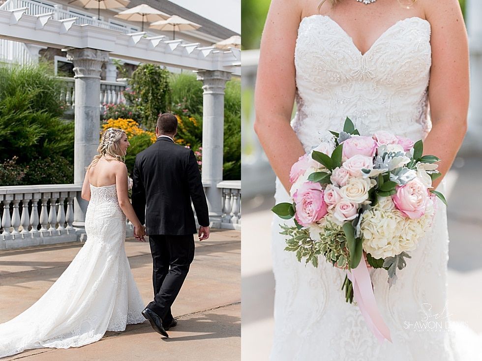 Bride and groom walking in a garden, bride holding a pink bouquet in a white gown