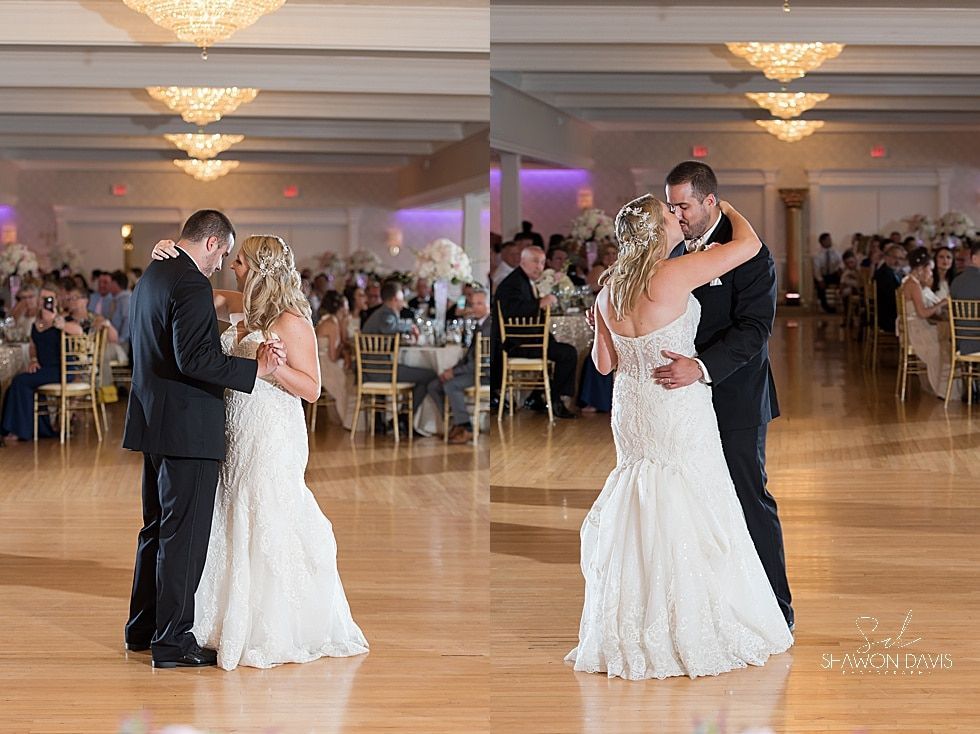 Two couples slow-dancing at a formal wedding reception in a ballroom with chandeliers and guests seated nearby