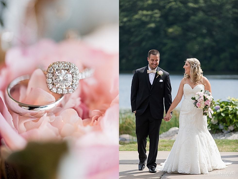 Wedding rings beside a bride and groom walking hand in hand outdoors among pink flowers