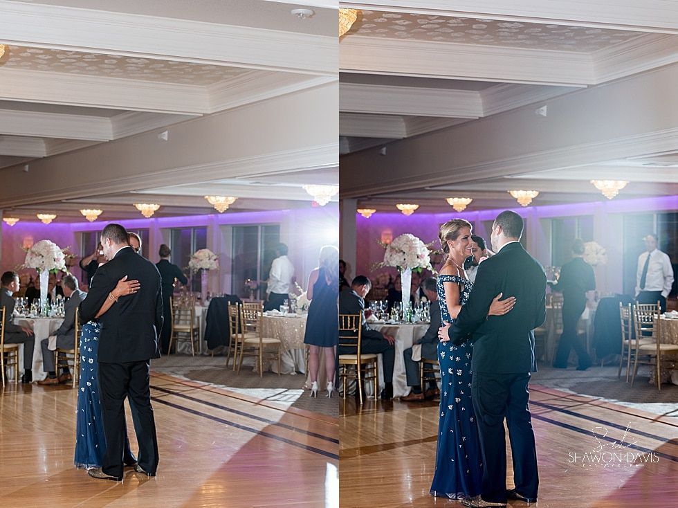 Couple slow dancing at a formal event in a banquet hall with purple lighting