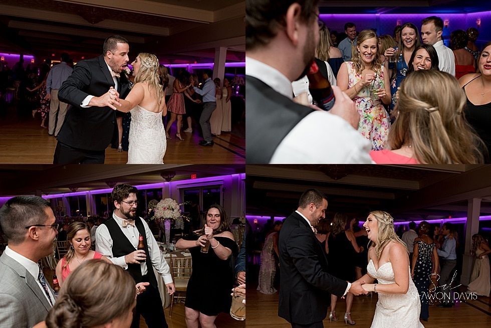 Wedding reception with newlyweds dancing and guests clapping under purple lights