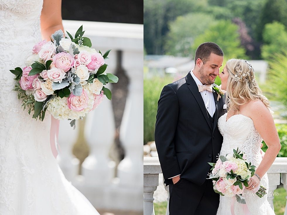 Bride and groom stand outdoors, holding pink and white bouquets at their wedding ceremony