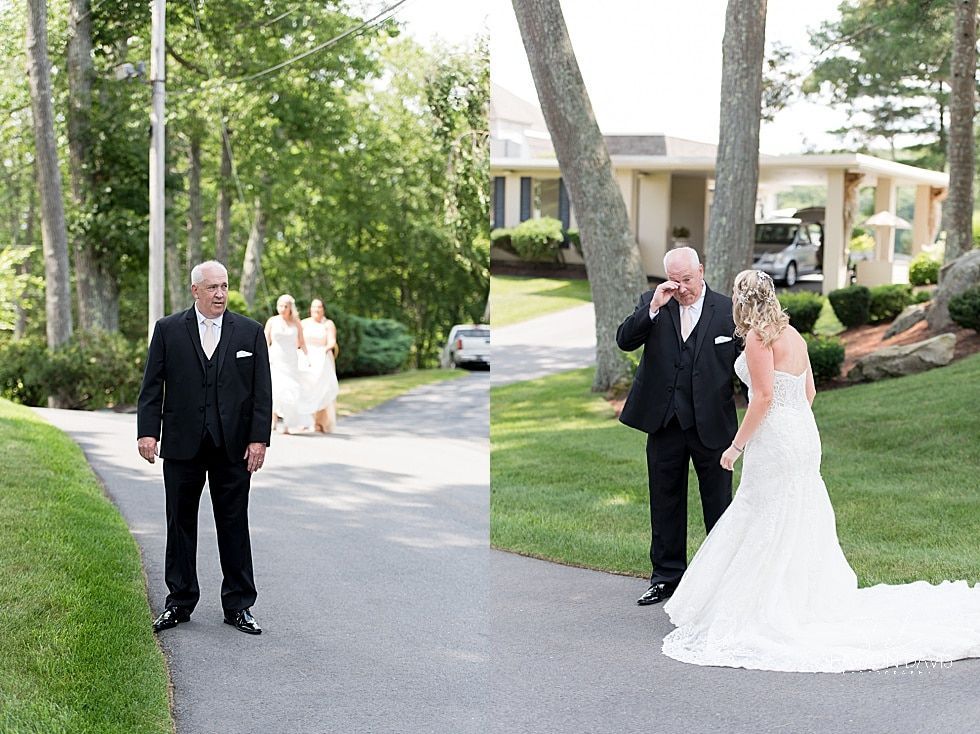 Wedding party gathered on a driveway outside a house, with the bride in a white gown and guests in formal wear