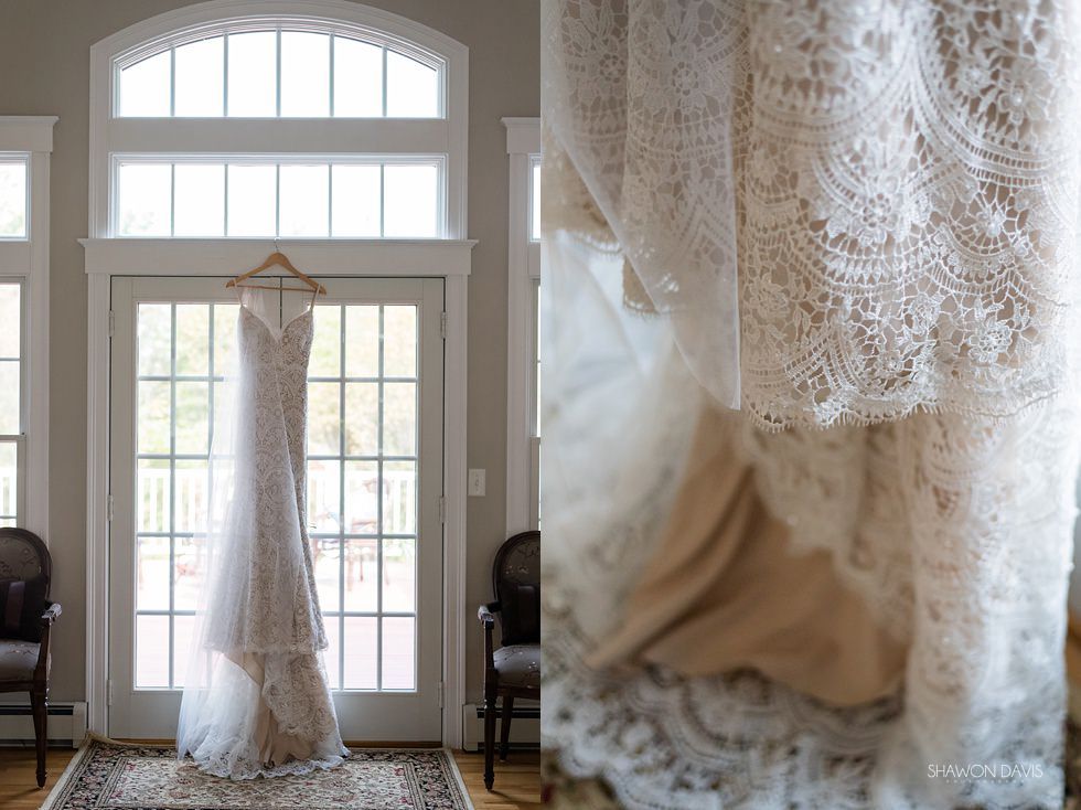 Lace wedding dress hanging in a bright doorway, with a close-up of the dress fabric on the right.