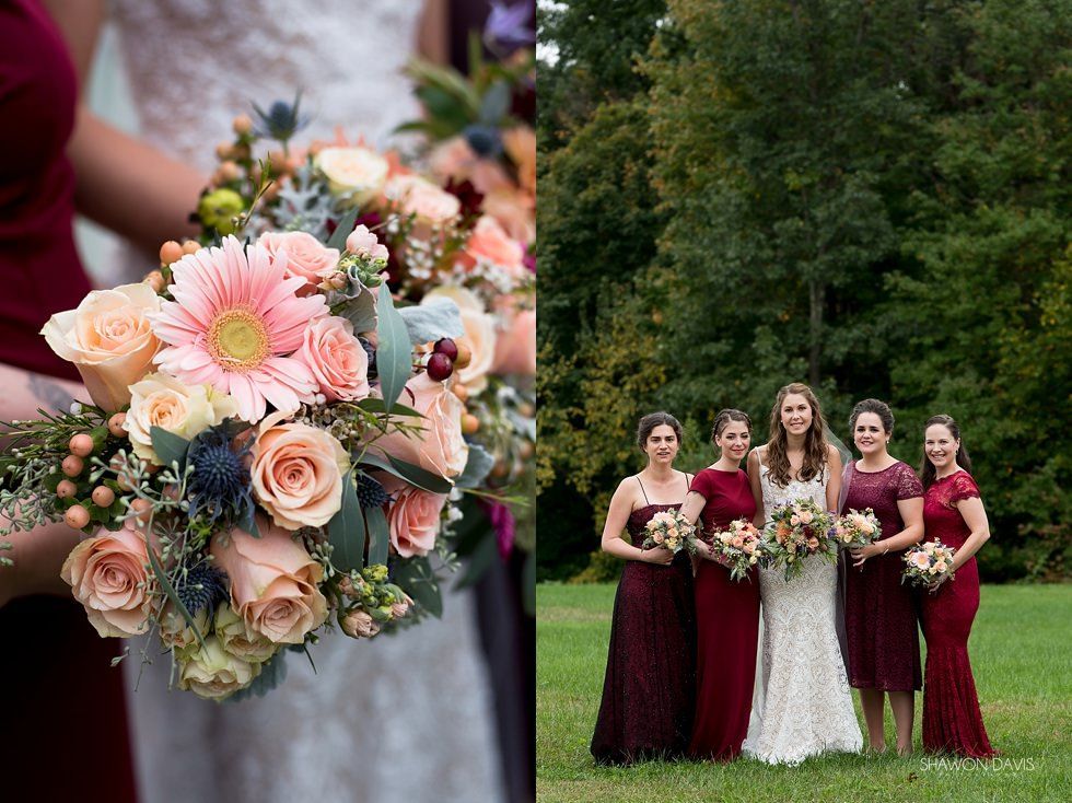 Bridal bouquet with pink roses and greenery beside a wedding party in burgundy dresses and white gown