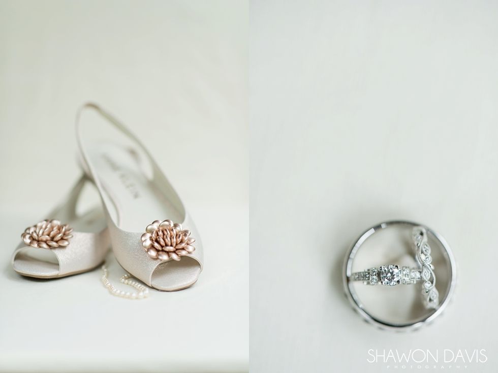 White heeled sandals and a jeweled ring on a white background