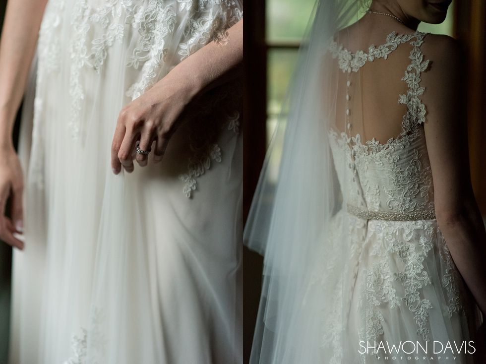Bride in a lace wedding gown with sheer back and flowing veil, shown in a soft, elegant close-up