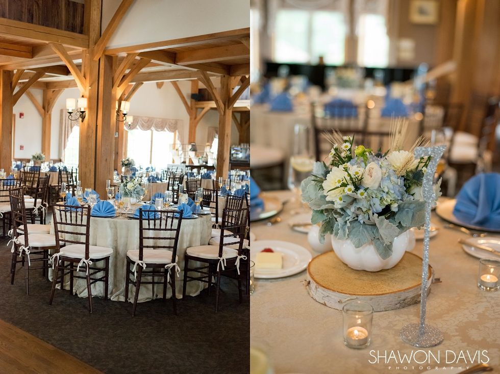 Elegant banquet hall with round tables, blue accents, and white floral centerpieces